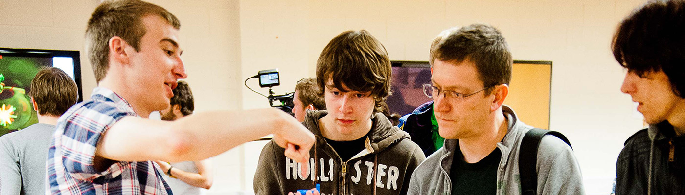 Three prospective students observing an open day demonstration