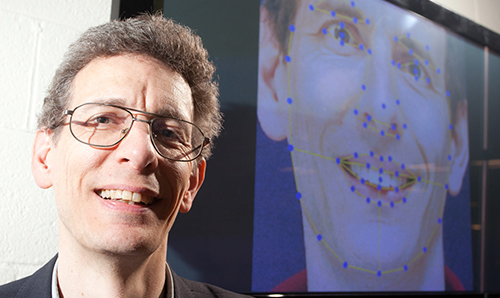 Professor stood in front of large projected screen